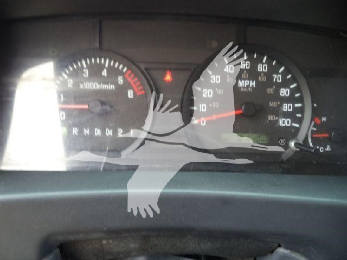 Isuzu NPR-HD dashboard showing speedometer up to 120 mph and tachometer up to 6,000 RPM. Gear selector PRNDL visible.