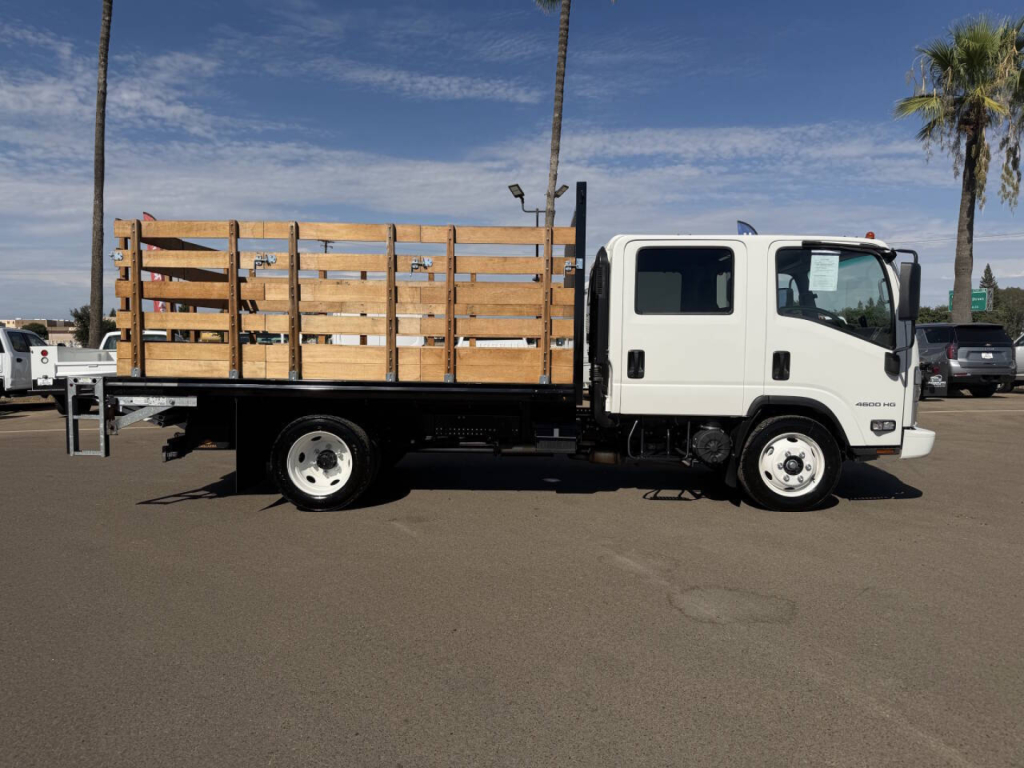 Flatbed truck with wooden stake bed shown in side view