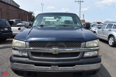 Chevrolet Silverado 1500 front view showing grille, bumper, and headlights in a used pickup lot.