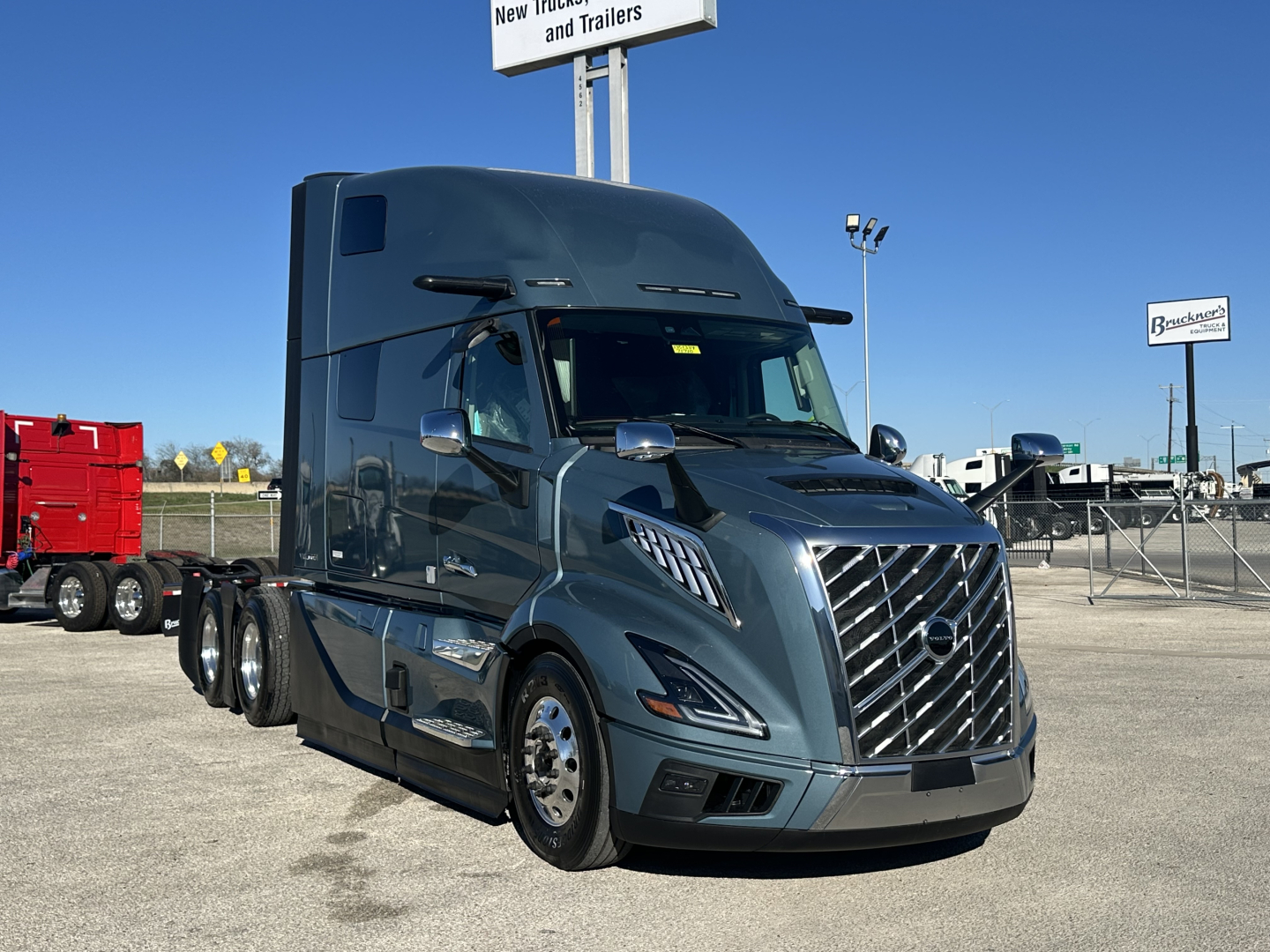 New 2026 Volvo VNL64T860 conventional sleeper truck showing chrome grille, side mirrors, and dual rear axles. VIN 4V4BC9EH6TN716870, stock 71710.