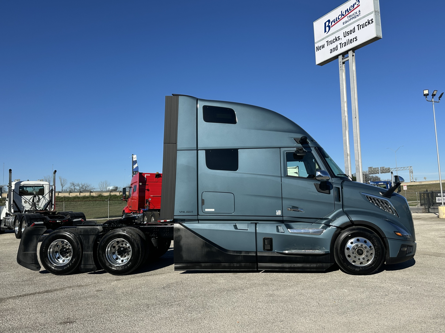 Volvo VNL64T860 tractor in blue-gray showing cab area and rear wheels.