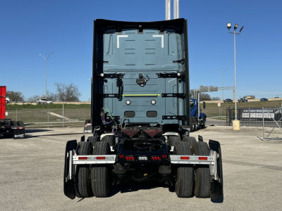 Volvo VNL cab and rear view showing chassis and tires, with fifth-wheel and rear bumper in view.