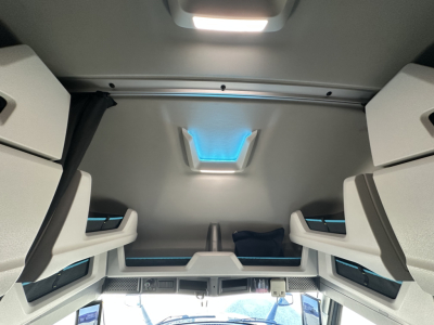 Volvo VNL64T860 sleeper cab interior view showing bunk area and overhead ceiling with blue ambient lighting.