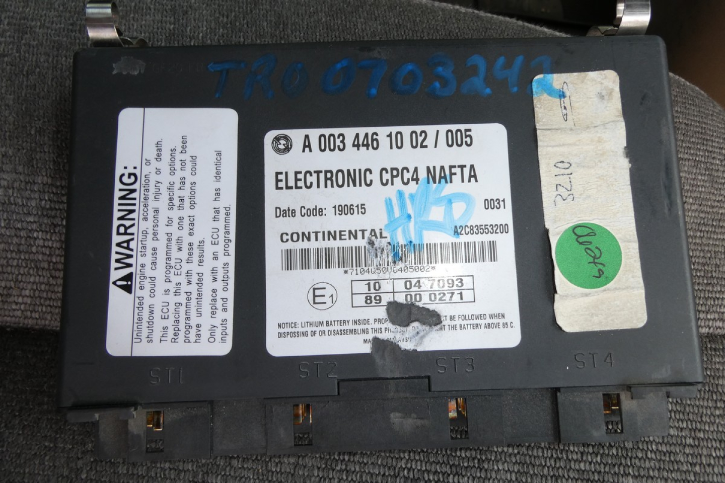 Electronic CPTC reset label on a Freightliner CASCADIA 125 engine control module with warning sticker and serials visible.