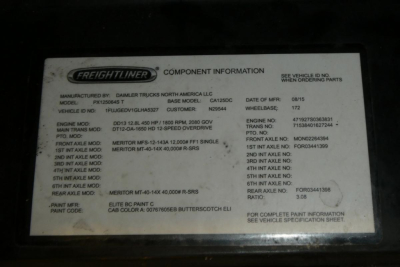Freightliner engine access panel showing component information label with model, base model, engine, and paint codes.