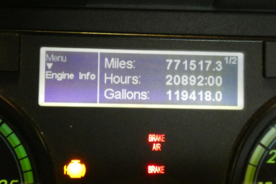 Dashboard screen showing vehicle hours, miles, and gallons: Miles 771,517.3; Hours 20892:00; Gallons 119,418.0 with brake indicators and warning lights.