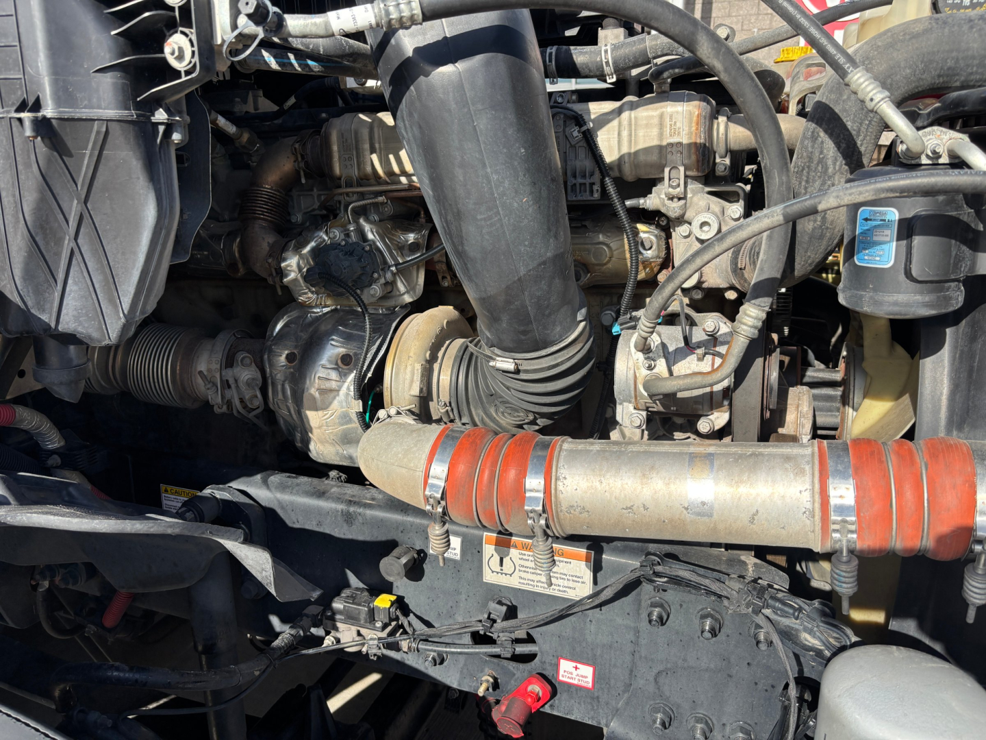 Engine bay of a Freightliner PT126064ST showing hoses, pipes, and component labels.