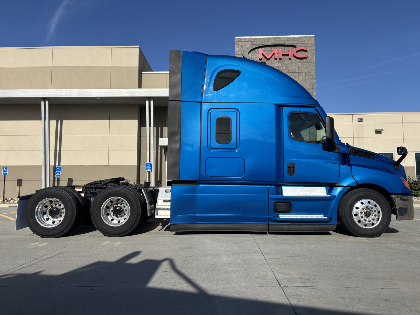 Freightliner PT126064ST truck side profile showing blue sleeper cab and chassis with 2 rear axles.