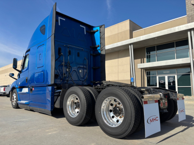 Truck rear view showing dual rear axles and blue Freightliner cab, day time, stock number 0632258 visible