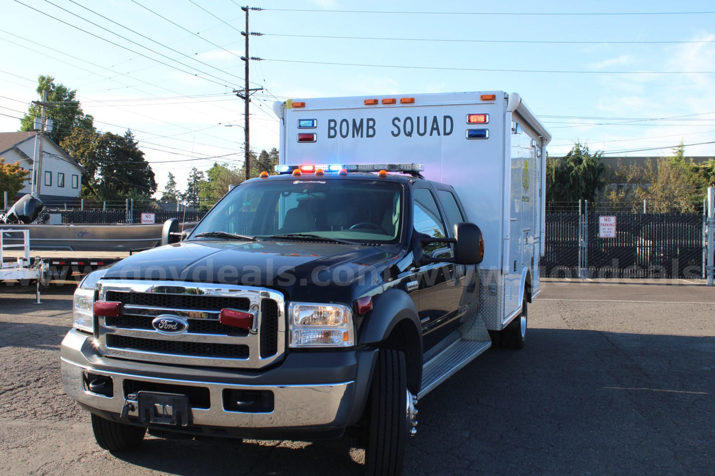 Ford F-550 cab and chassis truck with a box body labeled BOMB SQUAD seen from front-left angle