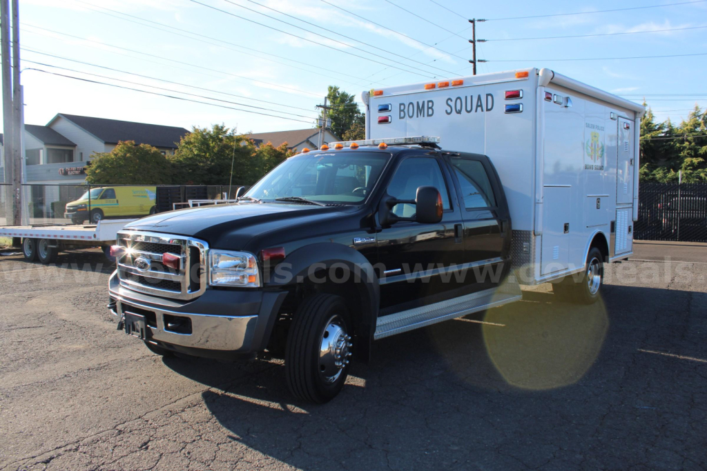 2005 Ford F-550 cab and chassis with a white Bomb Squad utility body in a dealership lot.