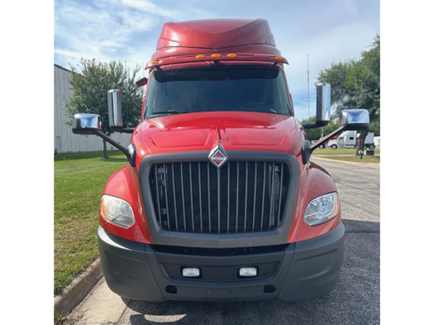 Front view of a red 2020 International LT625 truck with large chrome grille, rectangular headlights, and dual bumper lights.