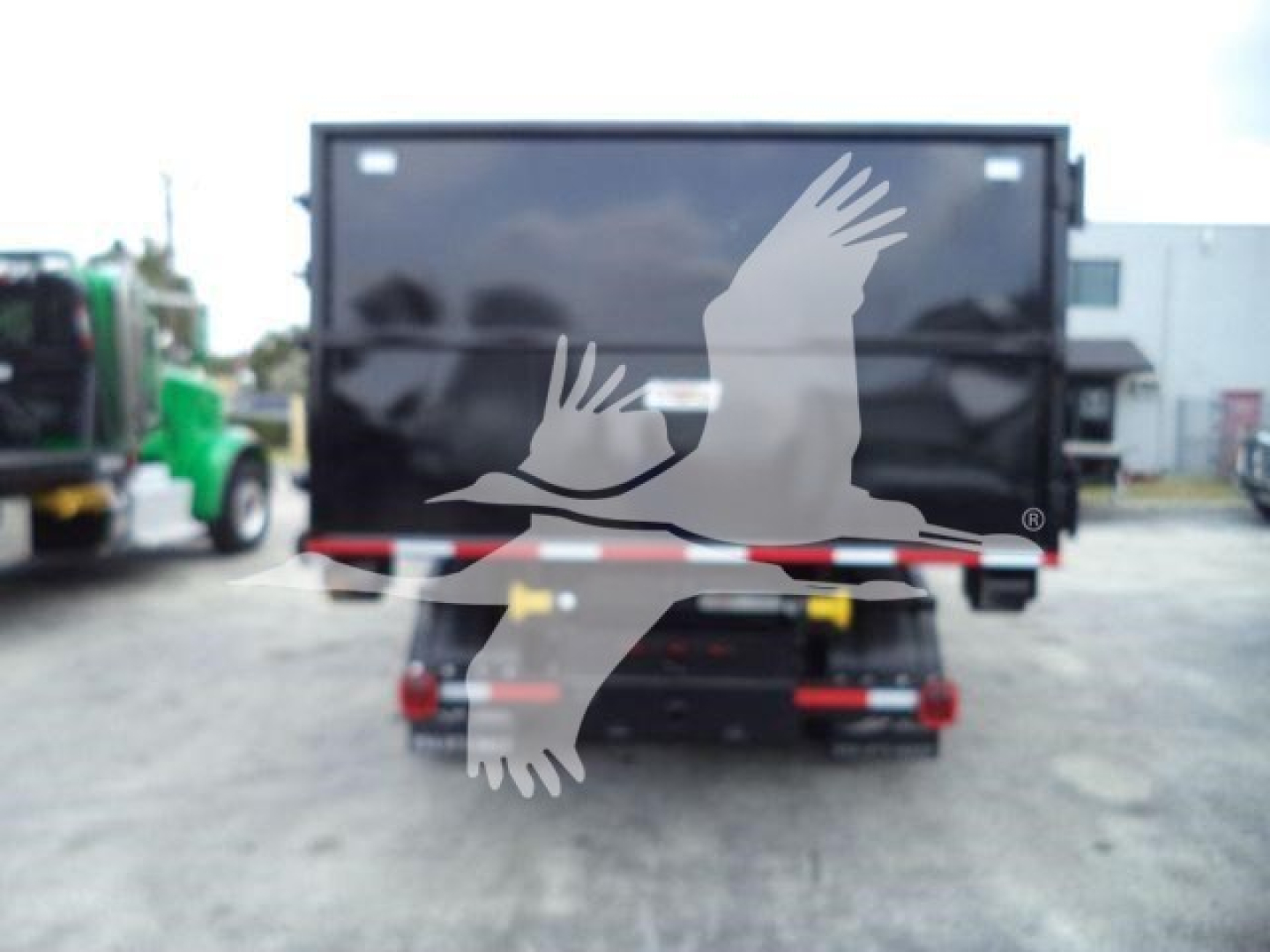 Rear view of a 2023 Chevrolet Silverado 6500HD dump truck with a large enclosed cargo area, showing taillights and bumper.