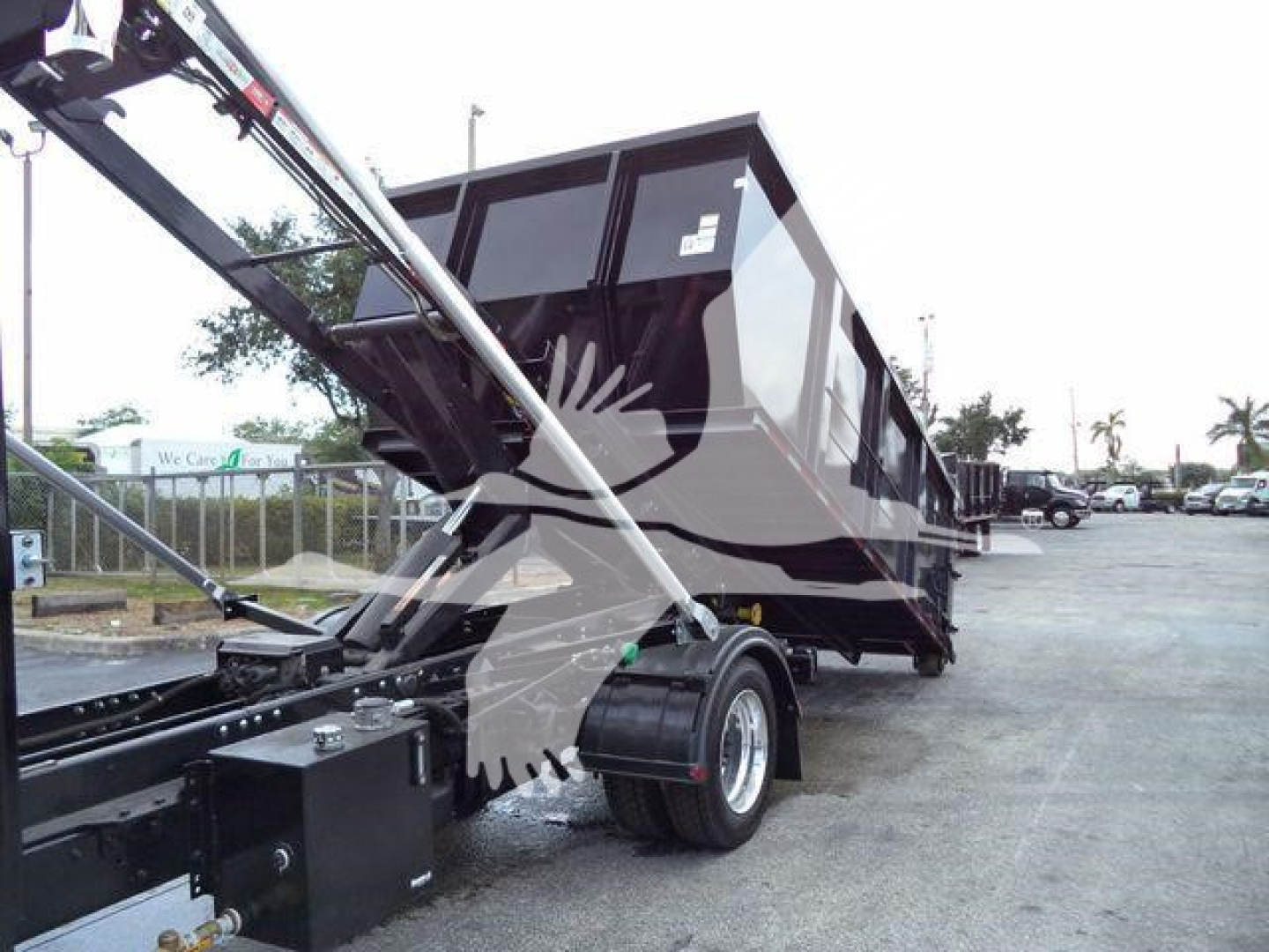 Dump trailer with hydraulic arms and a black dump bed, side view showing tires and chassis.