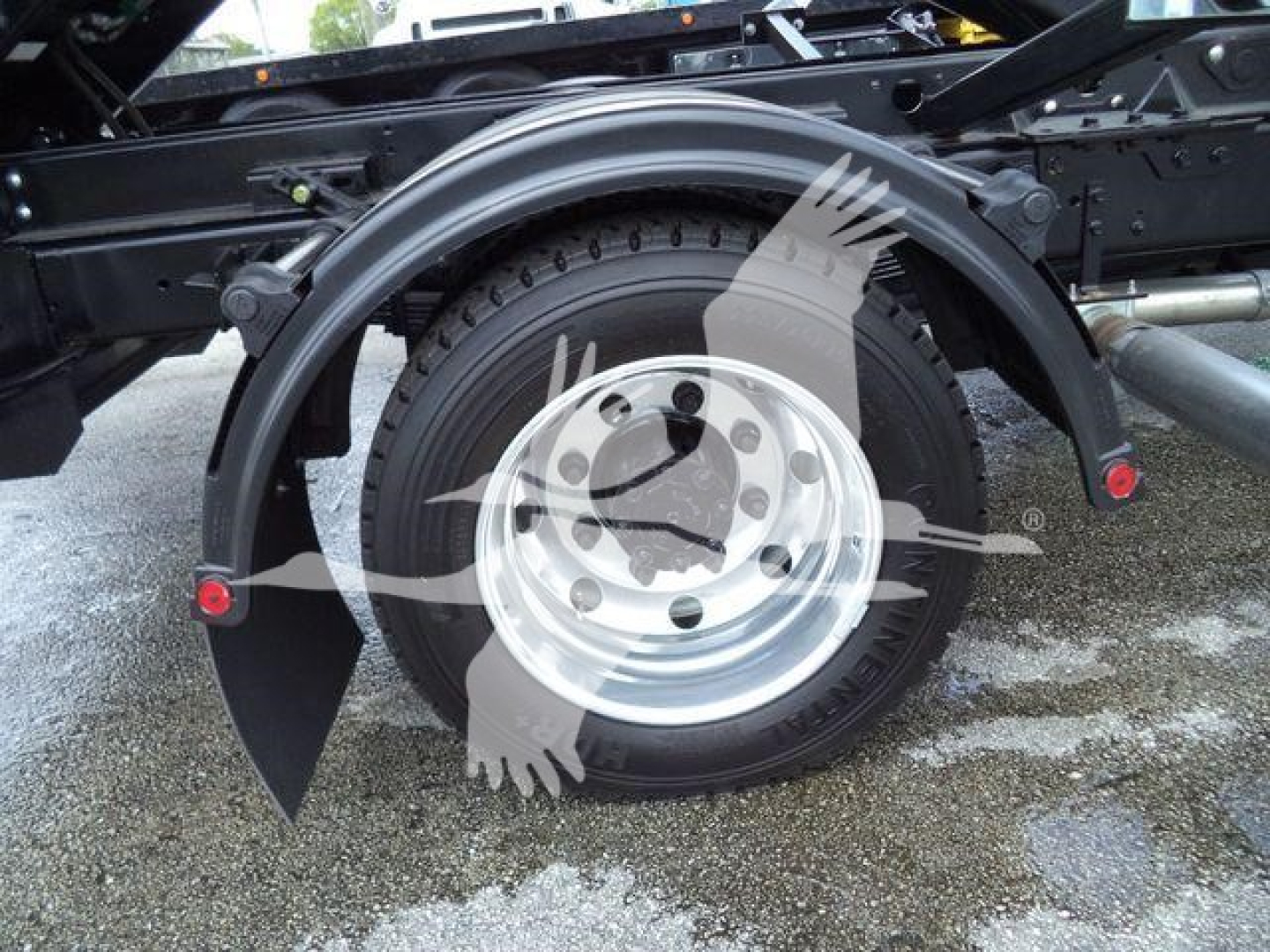 Truck rear wheel and fender of a 2023 Chevrolet Silverado 6500HD chassis showing wheel, tire, and surrounding frame components.