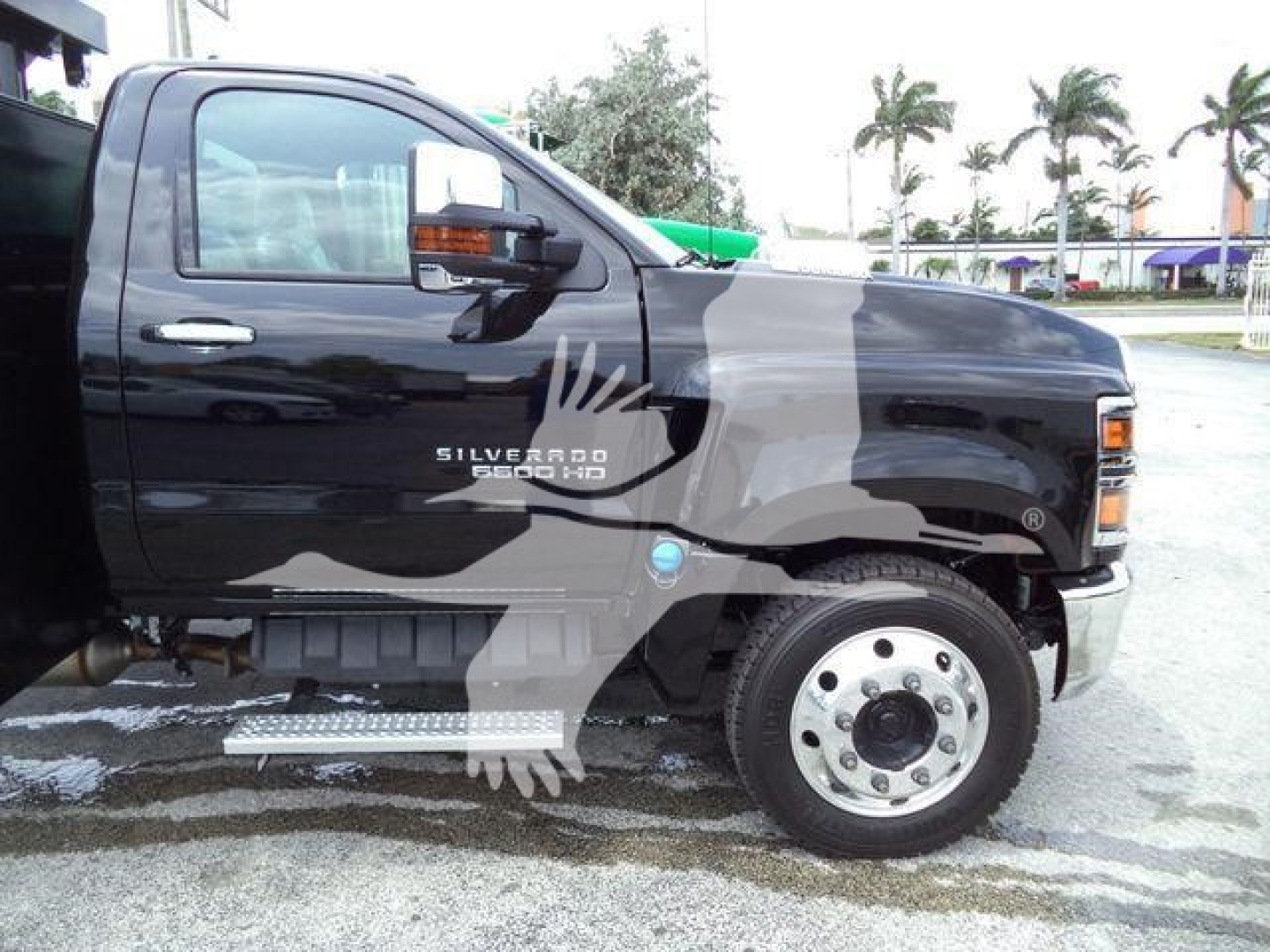 Chevrolet Silverado 6500HD truck cab side view showing Silverado HD badge and running board