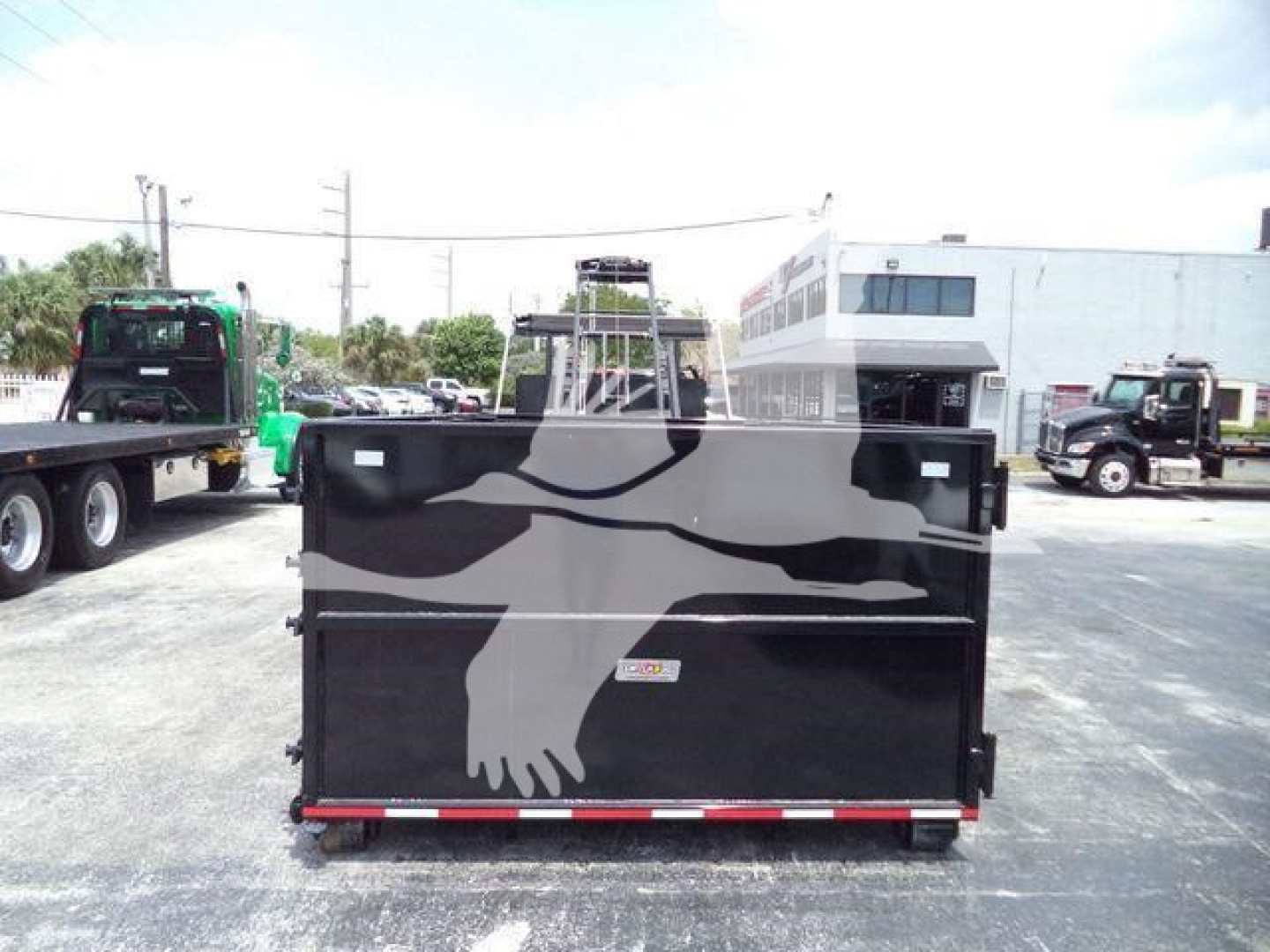 Truck bed of a 2023 Chevrolet Silverado 6500HD rear view showing a black dump bed with reflective tape and latching mechanisms.