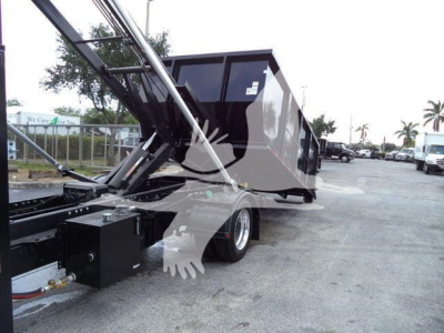 Truck bed of a 2023 Chevrolet Silverado 6500HD with dump bed in raised position showing hydraulic cylinders and chassis.