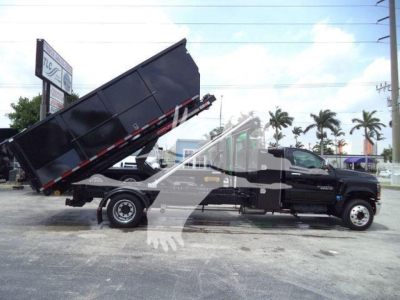 2023 Chevrolet Silverado 6500HD dump truck side view showing black cab and bed in raised position.