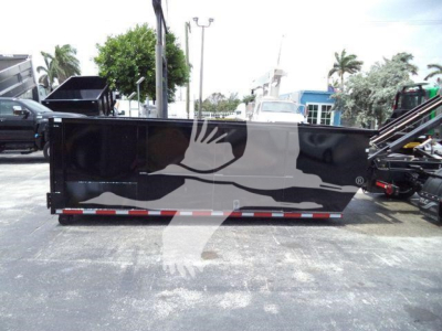Side view of a Chevrolet Silverado 6500HD dump bed trailer with black painted container and white graphic; no visible text legible.