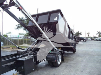 Dump trailer with hydraulic arms and a black dump bed, side view showing tires and chassis.