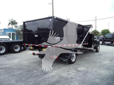 Back view of a black 2023 Chevrolet Silverado 6500HD dump truck trailer showing the cargo box and dual rear wheels.