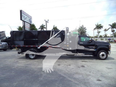 Truck side view of a black Chevrolet Silverado 6500HD dump with stock number 6500SNGTRUCK3 visible.