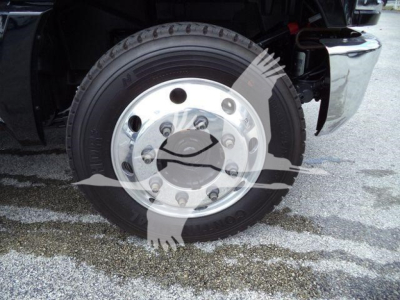 Front wheel and tire of a new Chevrolet Silverado 6500HD truck showing steel wheel and tire sidewall