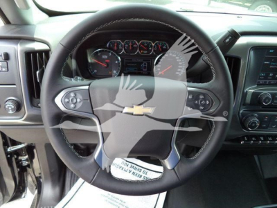 Chevrolet Silverado 6500HD interior view showing steering wheel with Chevrolet emblem and dashboard gauges.