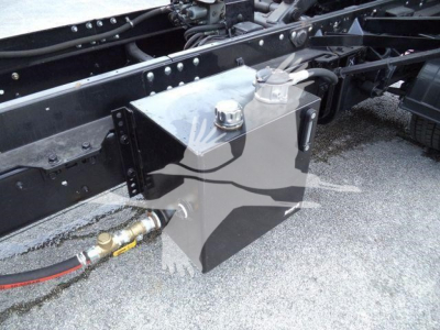 Vehicle chassis with a rectangular aluminum fuel or storage reservoir mounted to the frame, with fittings and hoses connected.