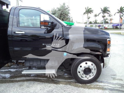Chevrolet Silverado 6500HD truck cab side view showing Silverado HD badge and running board