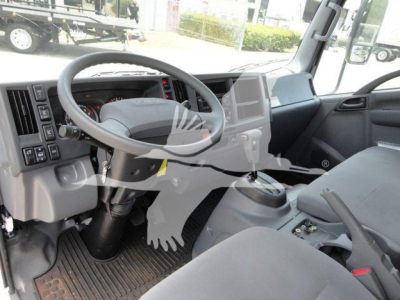 Isuzu NPRR/Nrr cab interior view showing steering wheel, gear shifter, dashboard, and center console.