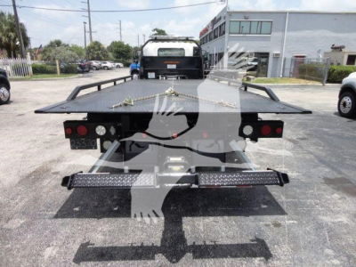 Isuzu NPRR rollback tow truck bed with dual rear LED light bar, flatbed, and rear bumper.
