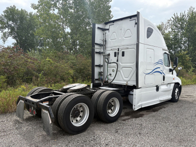 Freightliner Cascadia125 tractor cab with rear view showing dual rear axles and fifth wheel plate.
