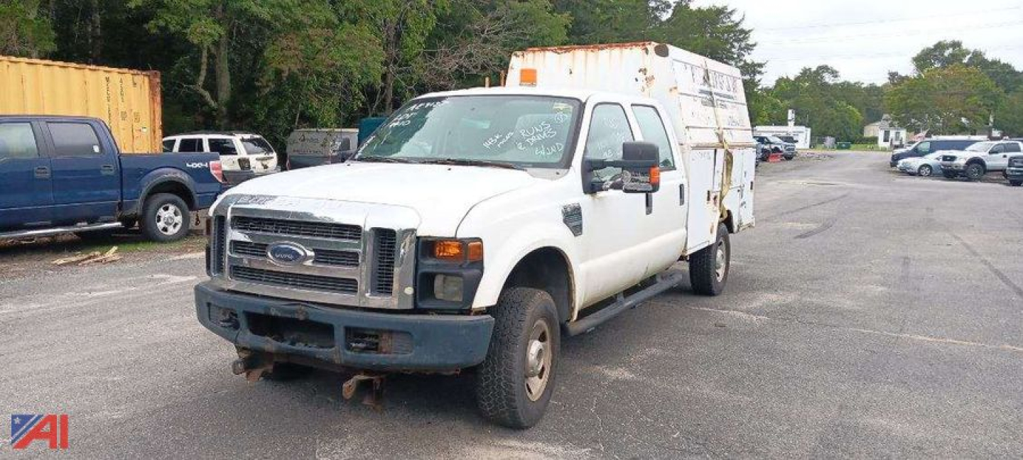 Ford F-350 Super Duty utility work truck with white cab and utility bed, front grille, bumper, and large side mirrors.