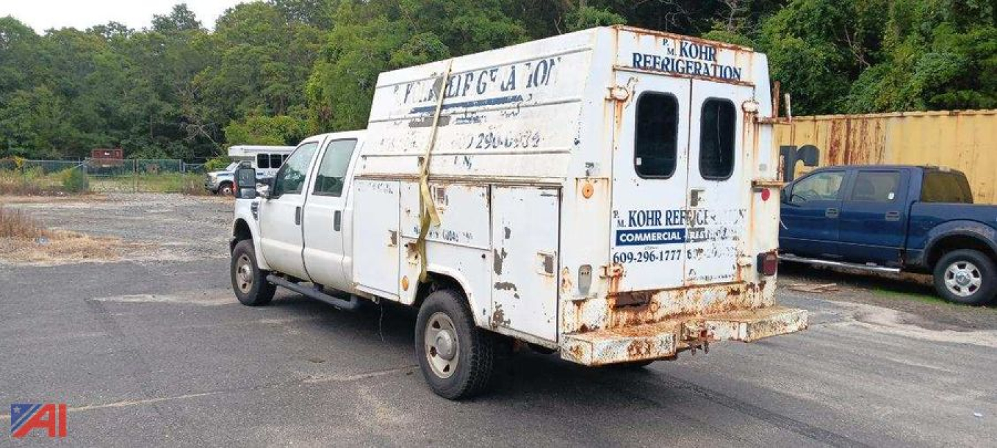 Rear and left side view of a white Ford F-350 utility service truck with a rusted utility box and KOHR Refrigeration markings.
