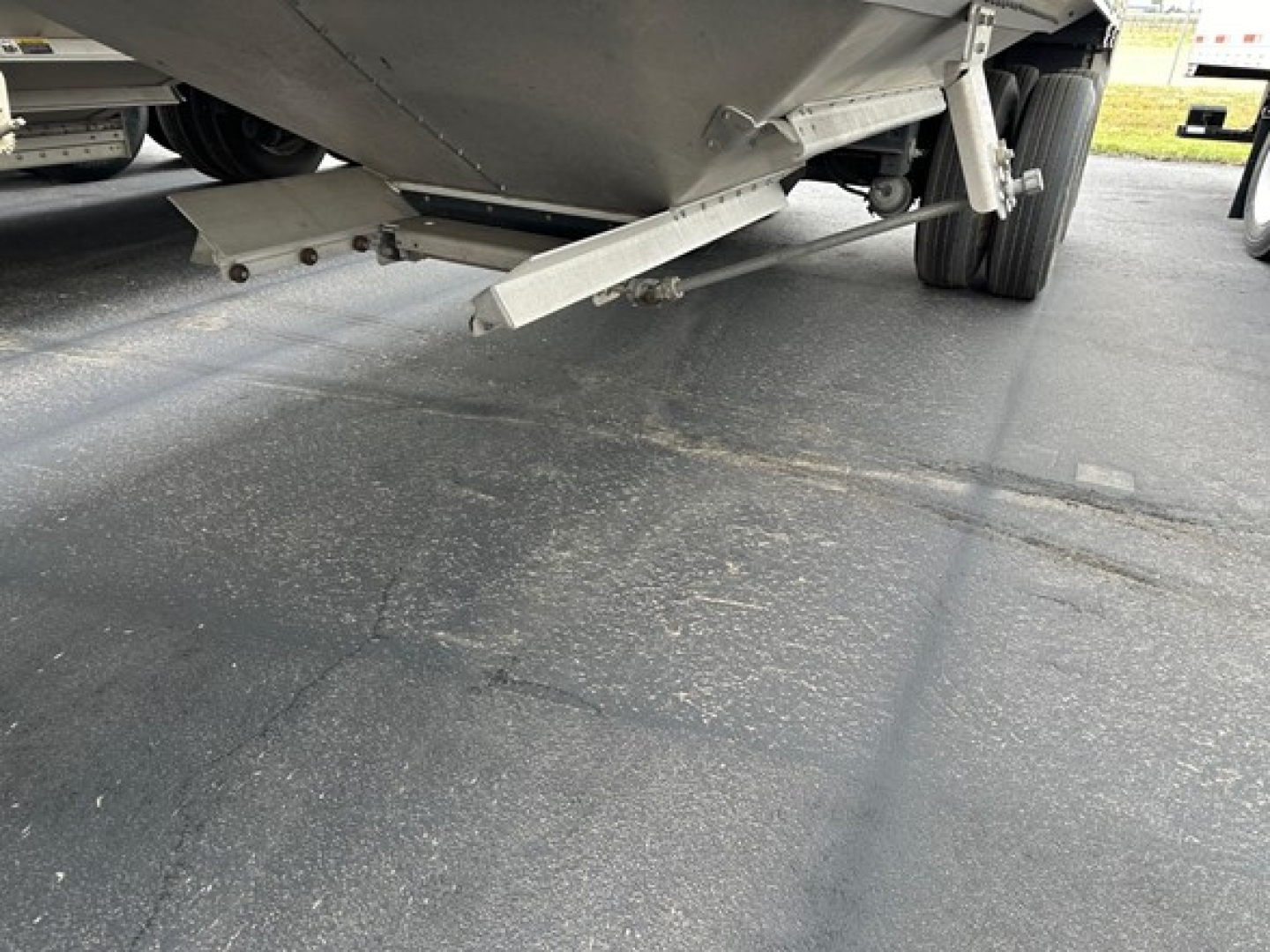 Timpte Super Hopper trailer underside showing support components and landing gear, with metal brackets and hitch area visible.