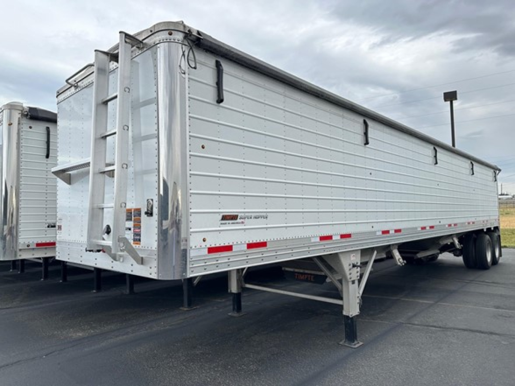 Timpte Super Hopper trailer in side and rear view showing aluminum hopper with ladders, undercarriage, and dual rear axle.