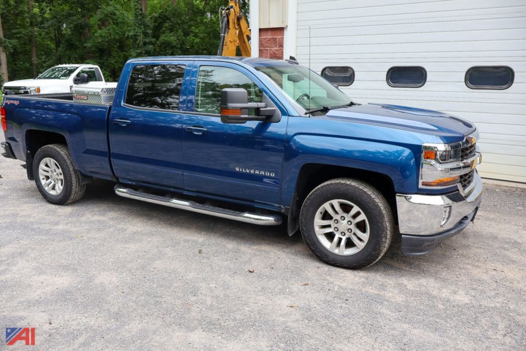 Chevrolet Silverado LT 1500 crew cab pickup truck in blue parked outdoors with chrome front bumper and running boards.