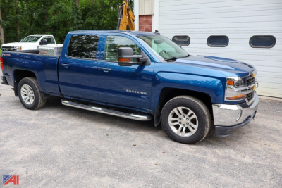 Chevrolet Silverado LT 1500 crew cab pickup truck in blue parked outdoors with chrome front bumper and running boards.