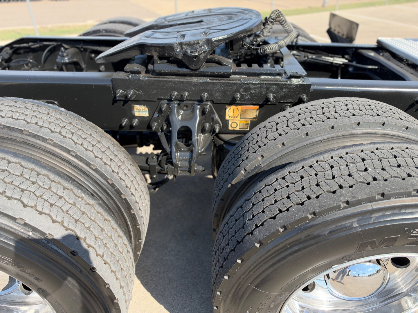 Peterbilt 579 tractor rear view showing dual rear axles and fifth wheel mounting with visible tires and chassis components.