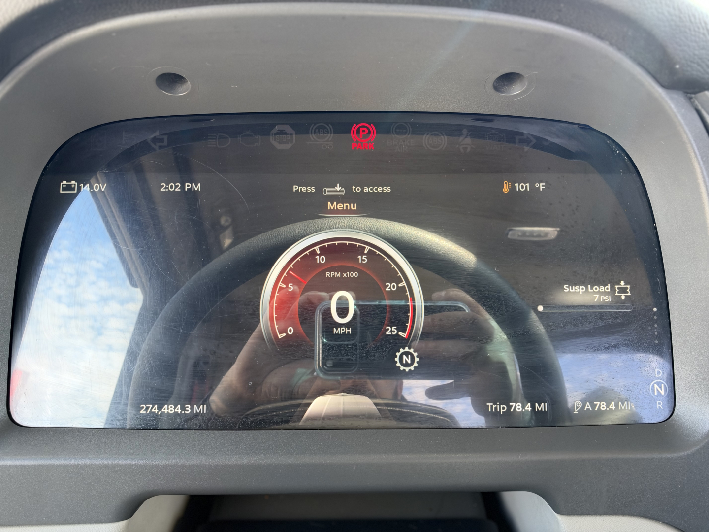 Truck instrument cluster on a Peterbilt 579 digital dash showing 0 MPH, RPM gauge, and various readouts, with VIN and stock info overlaid in the photo.