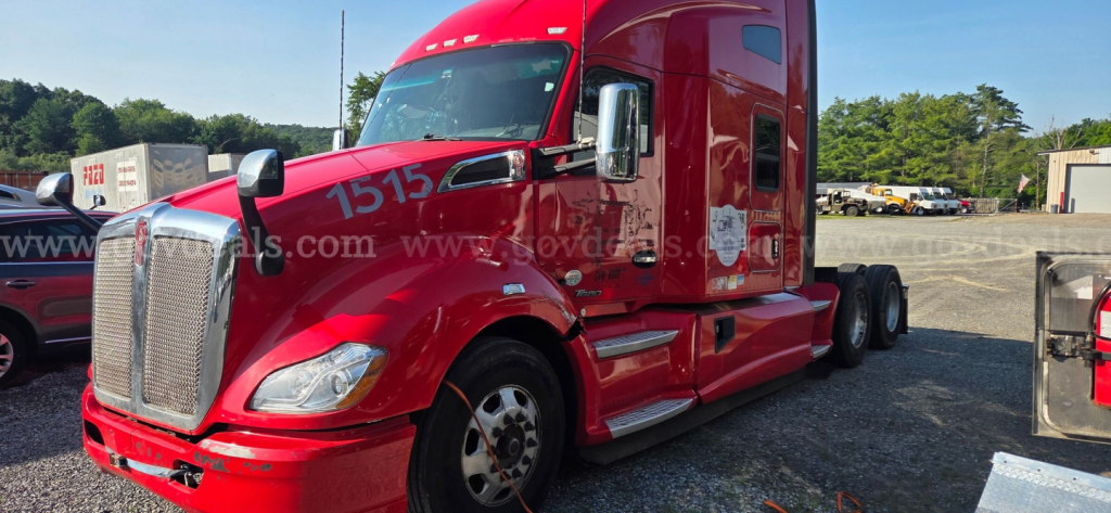 Kenworth T680 tractor-trailer cab in red, front-left view with chrome grille and sleeper, showing partial number '7515' on windshield and text on door.