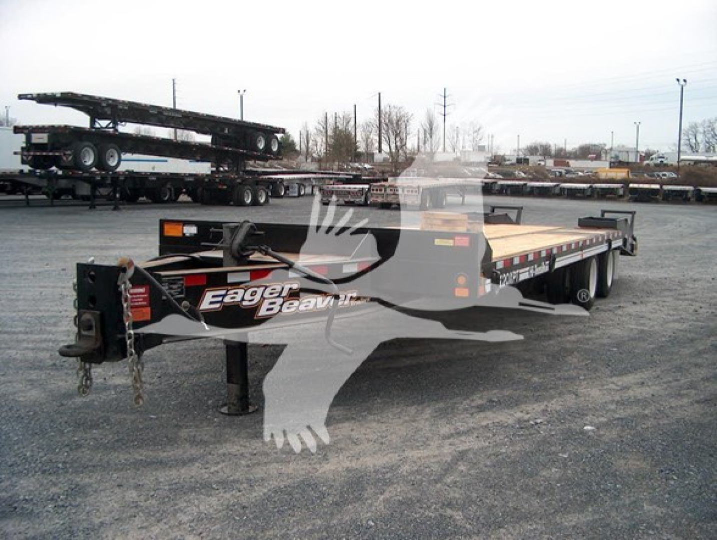 Eager Beaver 20Xpt flatbed trailer showing front hitch area and brand logo on side.