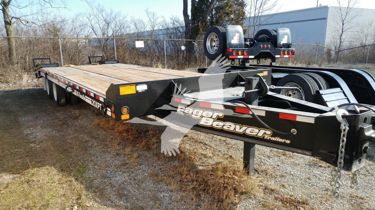 Flatbed trailer in service position showing Eager Beaver logo and hitch assembly.