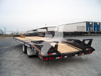 Trailer rear view showing flatbed trailer with wooden deck, dual rear axles, and tail ramp.