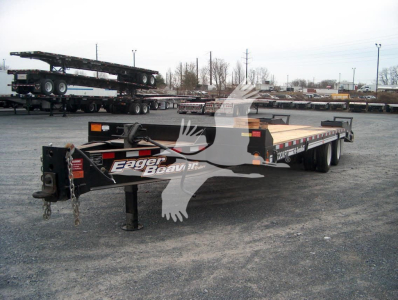Trailer showing Eager Beaver logo and flatbed with dual rear axles and Gooseneck hitch.