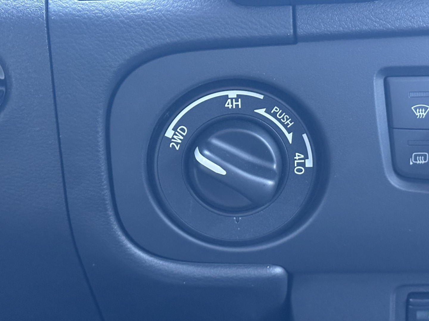 Vehicle control dial on Nissan Frontier showing 2WD/4WD options with 4H/4L markings and a knob in center.
