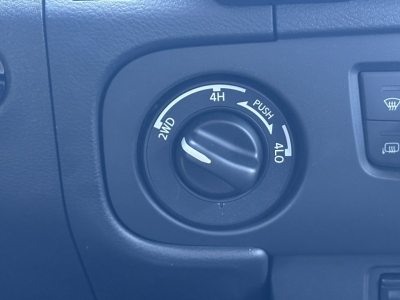 Vehicle control dial on Nissan Frontier showing 2WD/4WD options with 4H/4L markings and a knob in center.