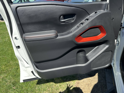 Frontier interior door panel view showing black panel with red handle accent and window controls.